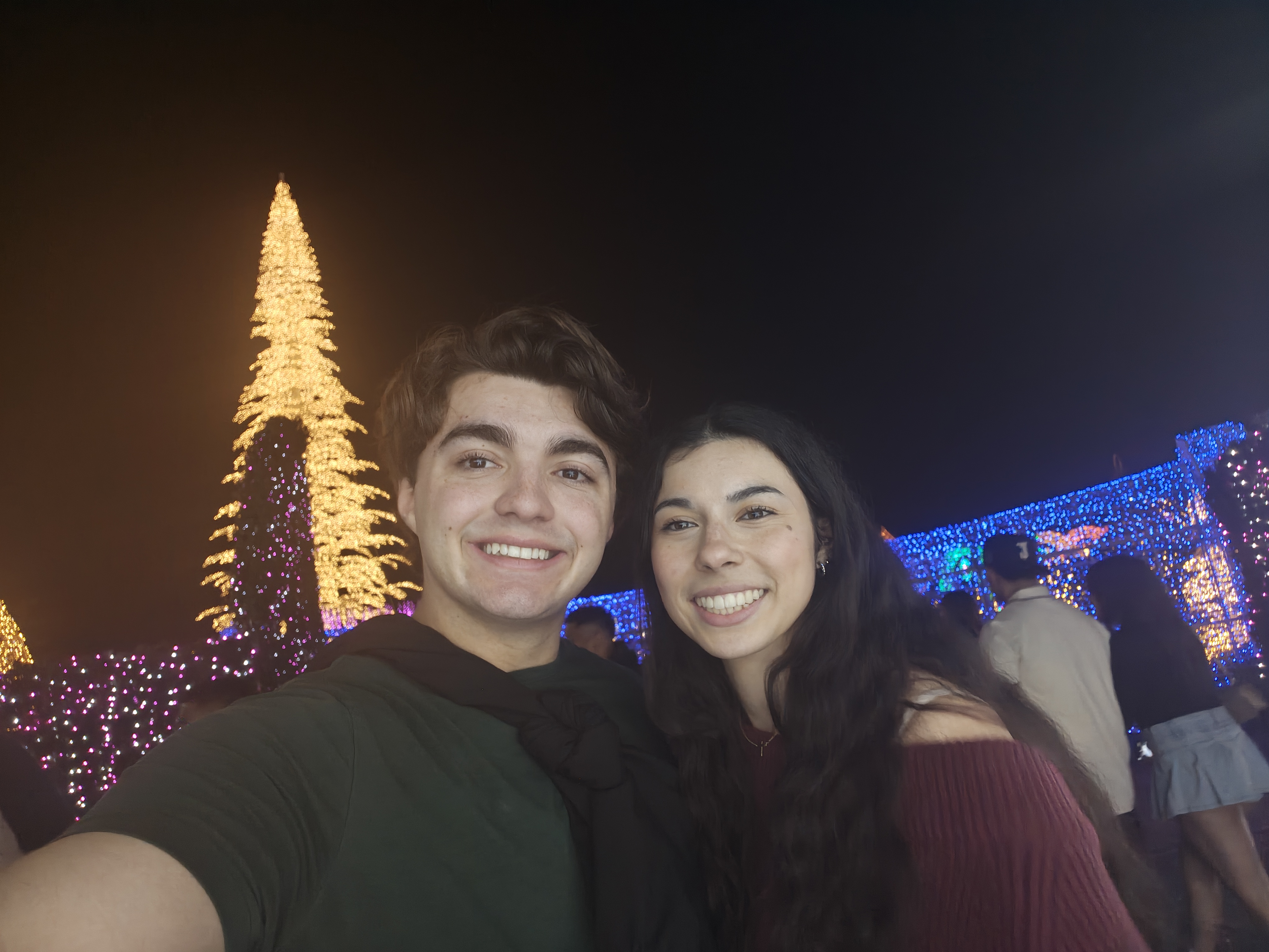 Us together surrounded by Christmas lights